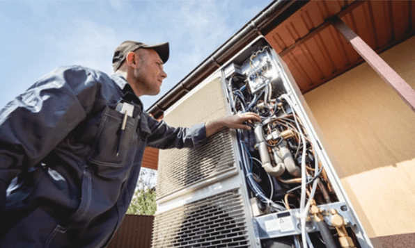 HVAC technician servicing home heating and cooling system